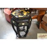 A Oriental style black lacquered stand
