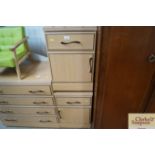 A wood effect chest fitted four drawers and a pair