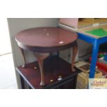 A circular coffee table on cabriole supports