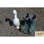 A garden planter in the form of boots and a garden