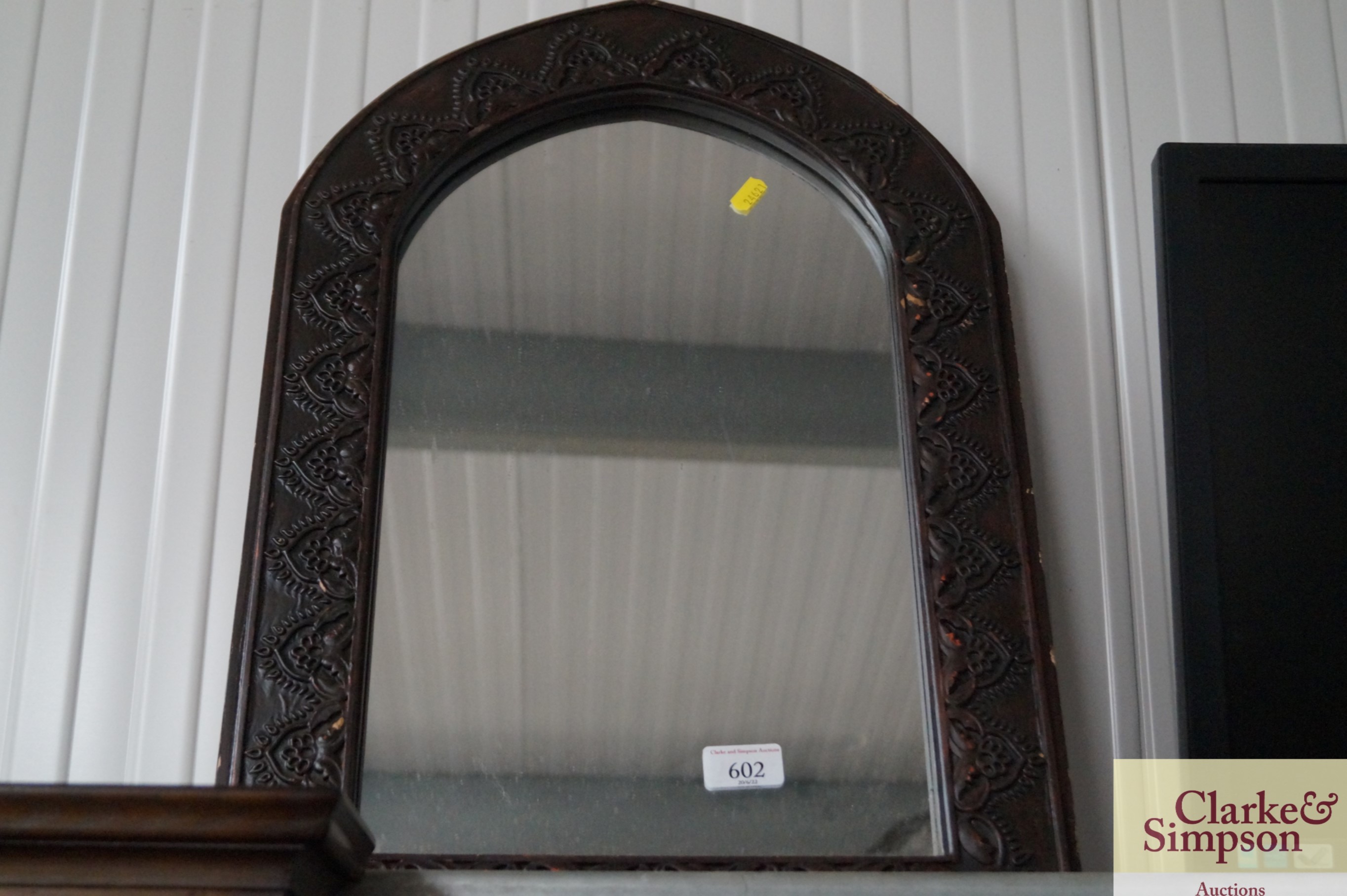 An arch framed wall mirror