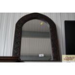 An arch framed wall mirror