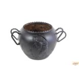 A cast iron Oriental pattern cauldron with double