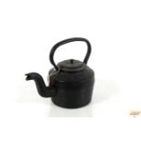 A heavy cast iron kettle