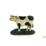 A cast iron door stop in the form of a Friesian co