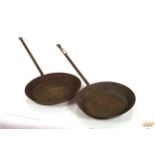 Two large iron frying pans