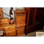 A pair of stripped pine two drawer bedside chests