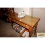 A stripped pine console table fitted two drawers,