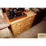 An antique stripped pine chest fitted two short ov