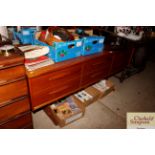 A teak effect sideboard fitted six drawers