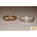 A 9ct gold bangle and silver bangle