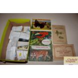 A collection of various tea cards, cigarette cards