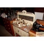 A marble topped washstand raised on cupboard base