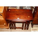 A nest of three oak occasional tables