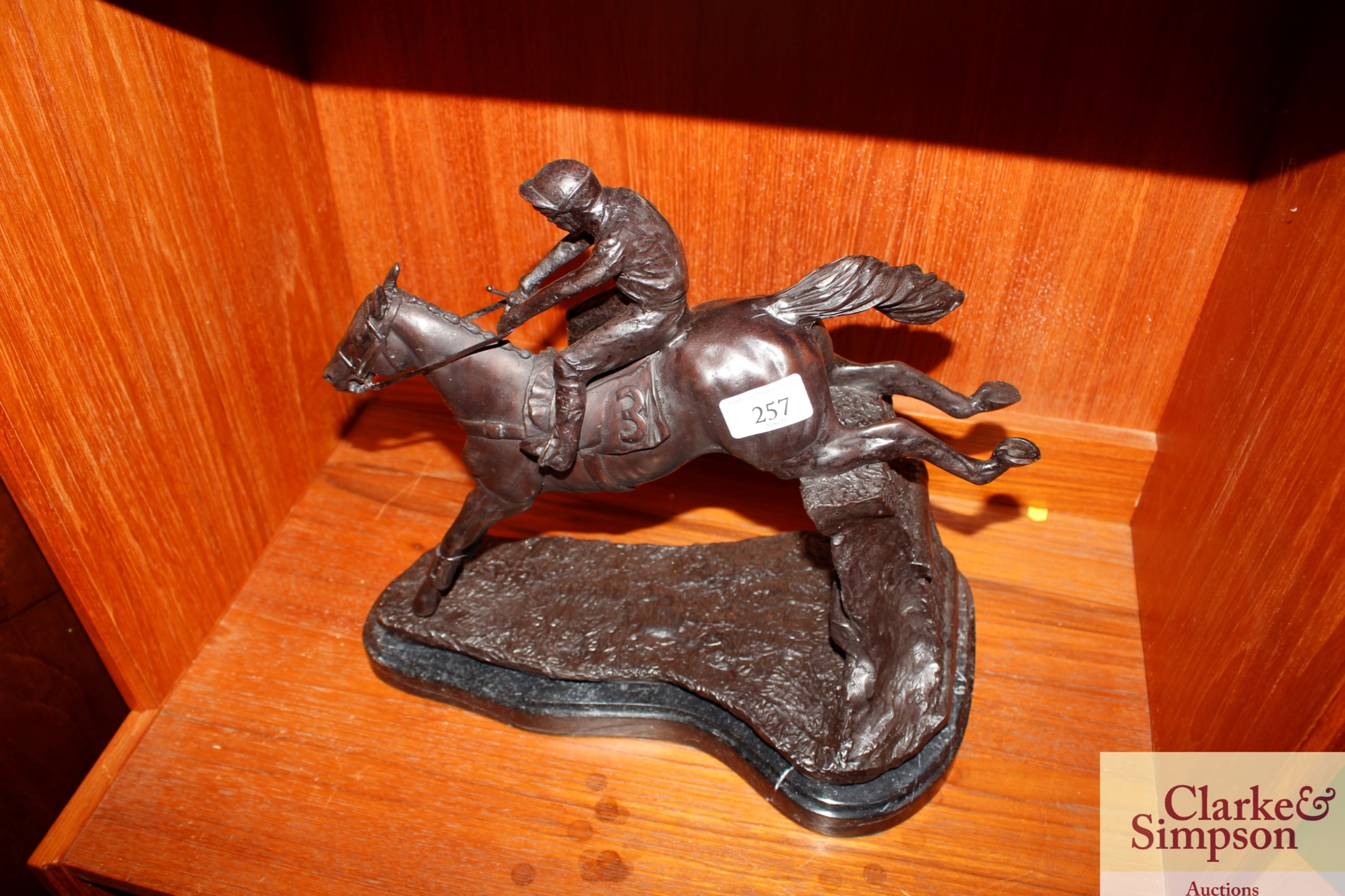 A bronze horse and jockey group