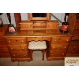 A stripped pine pedestal dressing table and stool