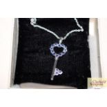 A Sterling silver and tanzanite set key pendant an