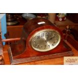 An oak cased three hole mantel clock