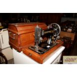 A Singer hand sewing machine in fitted case