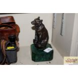 A bronze figure of a seated bear on faux Malachite