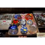 Nine various coloured glass paperweights