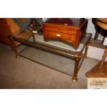 A heavy brass and plate two tier coffee table