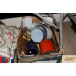 A box containing various vintage tins, fire iron,