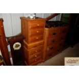 A pair of stripped pine three drawer bedside chest