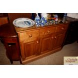 A stripped pine sideboard fitted three drawers