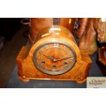 A 1920's figured walnut three hole mantel clock wi
