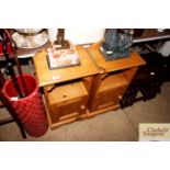 A pair of stripped pine bedside cupboards