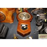 A small mahogany cased wall clock (pendulum inside