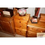 A pair of pine two drawer bedside chests