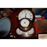 A wall clock; a mahogany mounted barometer; and a