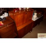 A Nathan teak bureau with cupboard below