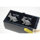 A pair of white metal hare cuff-links