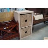 An Ikea two cubed unit with wicker baskets