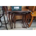 A nest of three mahogany occasional tables