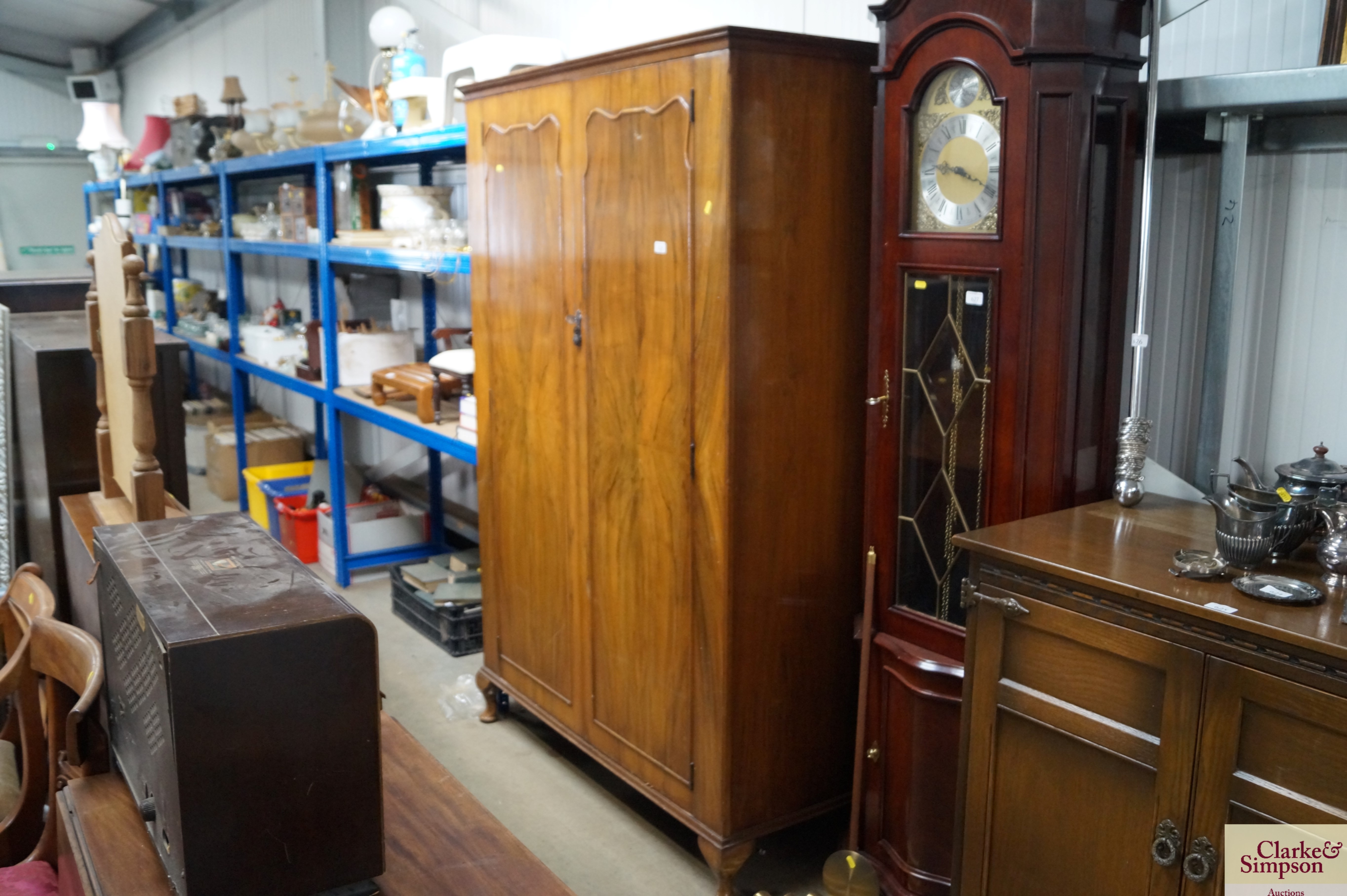 A walnut veneered two door wardrobe