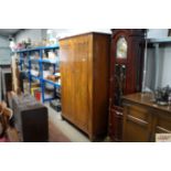 A walnut veneered two door wardrobe