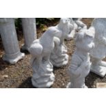 A pair of concrete garden ornaments in the form of