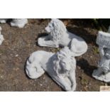 A pair of concrete garden ornaments in the form of