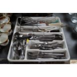 A tray of various cutlery and kitchen utensils