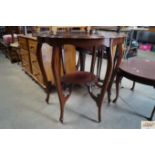 A mahogany two tier window table