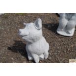 A concrete garden ornament in the form of a pig