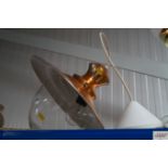 A copper effect hanging ceiling light