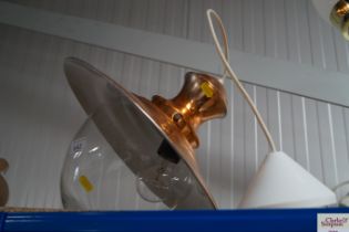 A copper effect hanging ceiling light