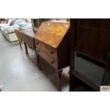 A walnut bureau raised on cabriole supports