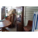 An oak and leaded glazed upright corner cabinet