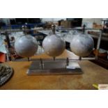 Three globes on a chrome stand